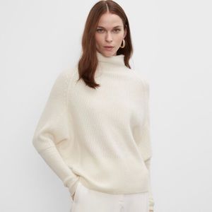 A warm and cozy cashmere sweater with an easy cocoon shape and relaxed mockneck.